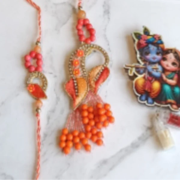 Thread of Unity – Designer Couple Rakhi Gift Set in Orange Shades for Brother & Bhabhi
